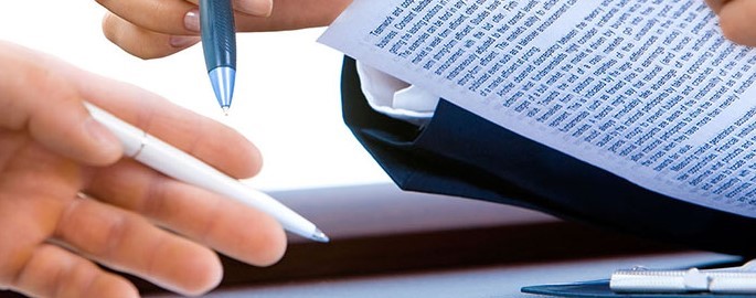 Image of business meeting, close-up on hands holding pens, notebooks