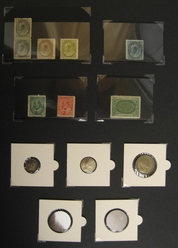 Coins and Stamps, 1903 A black sheet with various small coins and stamps taped to it