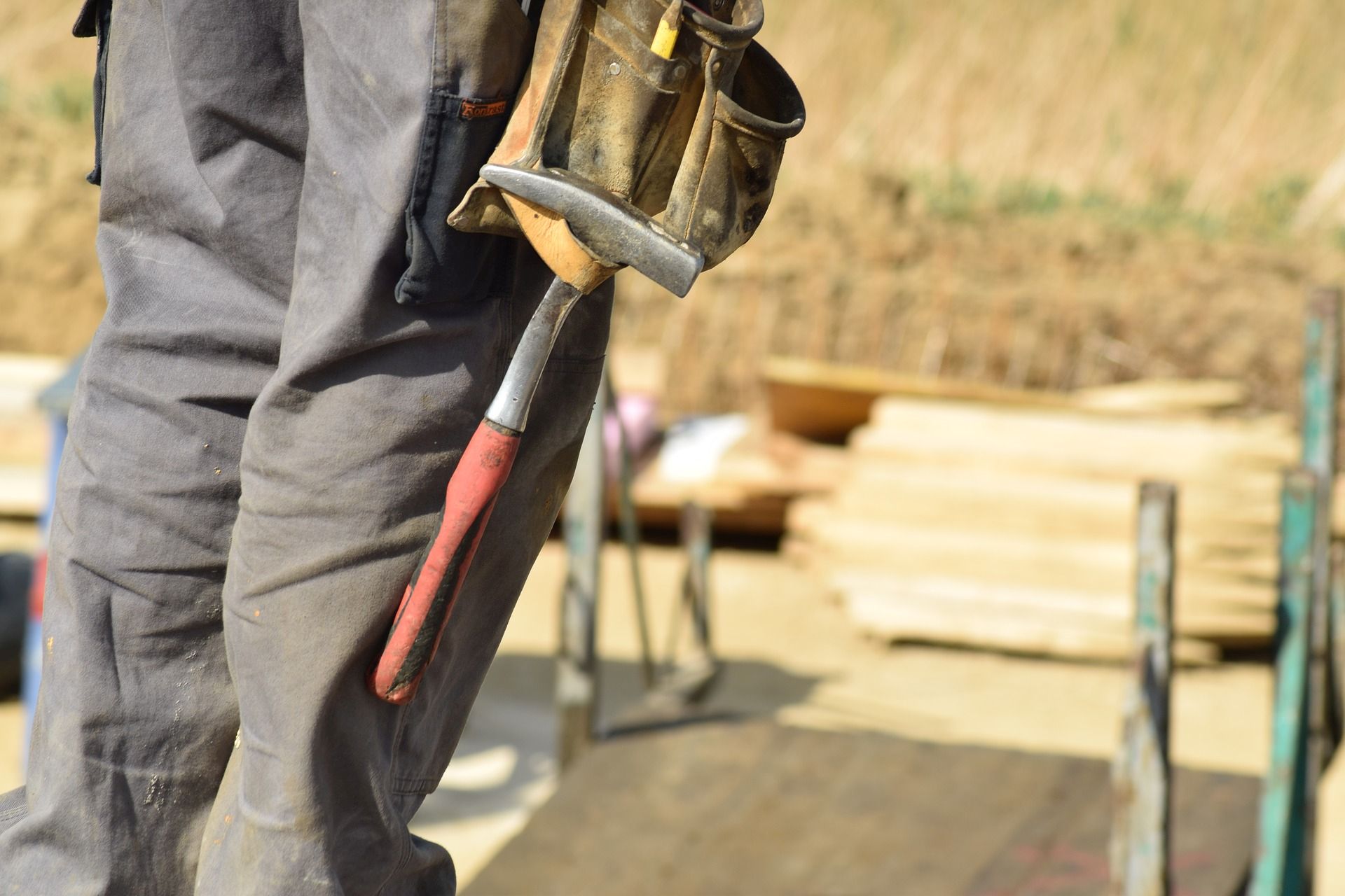 person with tool belt on construction site