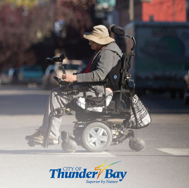 Image of assistive device user crossing street at crosswalk