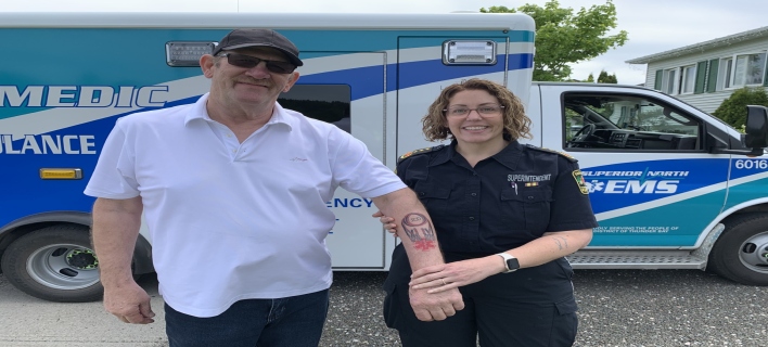 Randy Spekking and SNEMS Paramedic Paula Verin pose in front of an ambulance